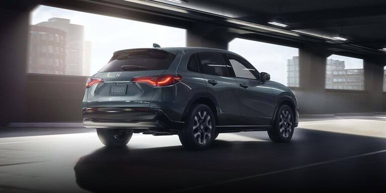 2027 Honda HR-V EX-L in Nordic Forest Pearl three quarter rear view driving through a city tunnel (Subcompact Crossover SUV).