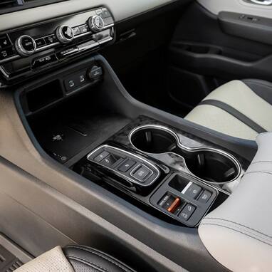 2027 Honda Passport center console featuring a wireless charger and USB ports (Mid-Size SUV).